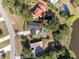 Aerial view of a home with a pool and surrounding trees near a pond at 102 Lake Ring Dr, Winter Haven, FL 33884