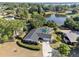 Aerial view of a brick home with a screened-in pool, spacious yard, and lake views at 102 Lake Ring Dr, Winter Haven, FL 33884