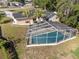 Aerial view of home showing backyard with a screened-in pool and palm trees at 102 Lake Ring Dr, Winter Haven, FL 33884