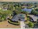 Aerial view of a home with a pool and a lake in the background at 102 Lake Ring Dr, Winter Haven, FL 33884