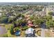 Picturesque aerial view of a residential area with tree coverage near a lake at 102 Lake Ring Dr, Winter Haven, FL 33884