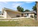 Backyard patio features an outdoor dining set, grill, and mature landscaping at 102 Lake Ring Dr, Winter Haven, FL 33884