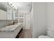 Elegant bathroom with double sinks, granite countertop, and decorative mirrors at 102 Lake Ring Dr, Winter Haven, FL 33884