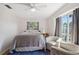 Cozy bedroom with a ceiling fan, a plush bed, and natural light from the window at 102 Lake Ring Dr, Winter Haven, FL 33884