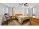 Well-lit bedroom featuring hardwood floors, a ceiling fan, and classic decor at 102 Lake Ring Dr, Winter Haven, FL 33884