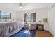 Bright bedroom with a large window, cozy sitting area, and a stylish rug at 102 Lake Ring Dr, Winter Haven, FL 33884
