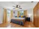 Cozy bedroom with natural light, hardwood floors, and a ceiling fan at 102 Lake Ring Dr, Winter Haven, FL 33884