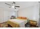 Charming bedroom featuring hardwood floors, a ceiling fan, and classic decor at 102 Lake Ring Dr, Winter Haven, FL 33884