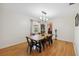 Open dining room with wood floors, modern lighting, and view into the kitchen area at 102 Lake Ring Dr, Winter Haven, FL 33884