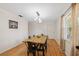 Bright dining room with wood floors, modern chandelier, and view of large window at 102 Lake Ring Dr, Winter Haven, FL 33884