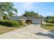 Beautiful single Gathering home with a large driveway and well manicured lawn and shrubs at 102 Lake Ring Dr, Winter Haven, FL 33884