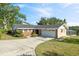 Single-story brick home with a two-car garage and well-maintained landscaping at 102 Lake Ring Dr, Winter Haven, FL 33884