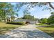 Charming single-story brick home boasts a well-manicured lawn and long driveway at 102 Lake Ring Dr, Winter Haven, FL 33884