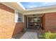Charming brick home featuring a cozy front porch with seating at 102 Lake Ring Dr, Winter Haven, FL 33884