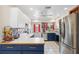 Well-lit kitchen with stainless appliances, blue cabinets, butcher block countertops, and ample counter space at 102 Lake Ring Dr, Winter Haven, FL 33884