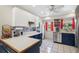 Bright kitchen with stainless steel appliances, blue cabinets, butcher block countertops, and tile flooring at 102 Lake Ring Dr, Winter Haven, FL 33884