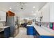 Open-concept kitchen view showcasing stainless steel appliances, cabinetry, and seamless transition to living area at 102 Lake Ring Dr, Winter Haven, FL 33884