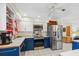 Kitchen with stainless steel appliances, blue lower cabinets, and white upper cabinets at 102 Lake Ring Dr, Winter Haven, FL 33884