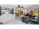 Inviting living room featuring tile floors, leather furniture, and a large wall-mounted television at 102 Lake Ring Dr, Winter Haven, FL 33884