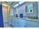 Beautiful bathroom features a dual-sink vanity with granite countertops and ample storage at 103 Lake Thomas Dr, Winter Haven, FL 33880
