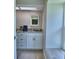 Bright bathroom with wood-look floors, updated vanity and plenty of sunlight at 103 Lake Thomas Dr, Winter Haven, FL 33880