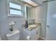 Bathroom features a vanity with marbled countertop, a toilet and a vanity mirror at 103 Lake Thomas Dr, Winter Haven, FL 33880
