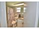 Compact bathroom features a shower, toilet, and vanity with a marbled countertop at 103 Lake Thomas Dr, Winter Haven, FL 33880