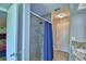 Bathroom with tile shower, granite countertop, and neutral color palette at 103 Lake Thomas Dr, Winter Haven, FL 33880