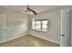 Bright bedroom featuring a ceiling fan, and a large window overlooking the landscape at 103 Lake Thomas Dr, Winter Haven, FL 33880