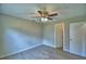 Bright bedroom with a ceiling fan, hardwood floors, and closet access at 103 Lake Thomas Dr, Winter Haven, FL 33880