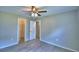 Neutrally decorated bedroom with closet and doorway access, featuring durable hardwood floors at 103 Lake Thomas Dr, Winter Haven, FL 33880