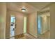 Open foyer featuring a front door with sidelights and stylish wood-look flooring at 103 Lake Thomas Dr, Winter Haven, FL 33880