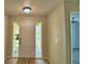 Bright entryway with light walls, a front door with sidelights and a hallway entrance at 103 Lake Thomas Dr, Winter Haven, FL 33880