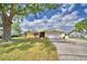 Lovely single-Gathering home with a well-maintained lawn, mature tree, and a two-car garage at 103 Lake Thomas Dr, Winter Haven, FL 33880