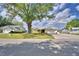 Well-maintained home with a large tree, a spacious driveway and a peaceful neighborhood setting at 103 Lake Thomas Dr, Winter Haven, FL 33880