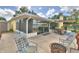 Exterior view showcasing screened lanai, patio, fire pit and spacious backyard with waterfront views at 103 Lake Thomas Dr, Winter Haven, FL 33880