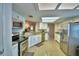 Modern kitchen with stainless appliances, granite counters, and sleek white cabinetry at 103 Lake Thomas Dr, Winter Haven, FL 33880