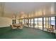 Enclosed waterfront lanai with dining table, ceiling fans, and glass doors offering stunning lake views at 103 Lake Thomas Dr, Winter Haven, FL 33880