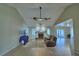 Spacious living room featuring a fireplace, ceiling fans, and sliding glass doors at 103 Lake Thomas Dr, Winter Haven, FL 33880