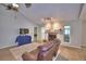 Comfortable living room with fireplace, television, and plenty of natural light at 103 Lake Thomas Dr, Winter Haven, FL 33880