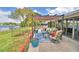 Inviting patio with cozy seating area, colorful plants, and serene waterfront views offers a relaxing outdoor retreat at 103 Lake Thomas Dr, Winter Haven, FL 33880