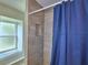 Modern tiled shower with niche and natural lighting from a window at 103 Lake Thomas Dr, Winter Haven, FL 33880