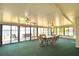 Enclosed sunroom with panoramic lake views, perfect for relaxation and dining at 103 Lake Thomas Dr, Winter Haven, FL 33880