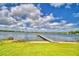 Beautiful lakefront view with a private dock extending into calm water at 103 Lake Thomas Dr, Winter Haven, FL 33880