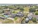 Aerial view of the single story home with a car port, a swimming pool, and lawns with mature trees at 1032 Tower Blvd, Lake Wales, FL 33853