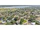 Aerial view of the houses in a suburban neighborhood surrounded by trees and green lawns near a lake at 1032 Tower Blvd, Lake Wales, FL 33853