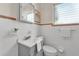 Clean half bathroom with white tiled walls, updated vanity, new fixtures, and lots of light at 1032 Tower Blvd, Lake Wales, FL 33853