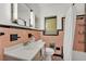 Retro bathroom with pink tile, black accents, updated toilet, and white shower curtain at 1032 Tower Blvd, Lake Wales, FL 33853
