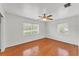 Empty bedroom with hardwood floors, two windows, and a ceiling fan at 1032 Tower Blvd, Lake Wales, FL 33853