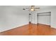 Bright bedroom features a ceiling fan, hardwood floors, and a closet with shelving at 1032 Tower Blvd, Lake Wales, FL 33853